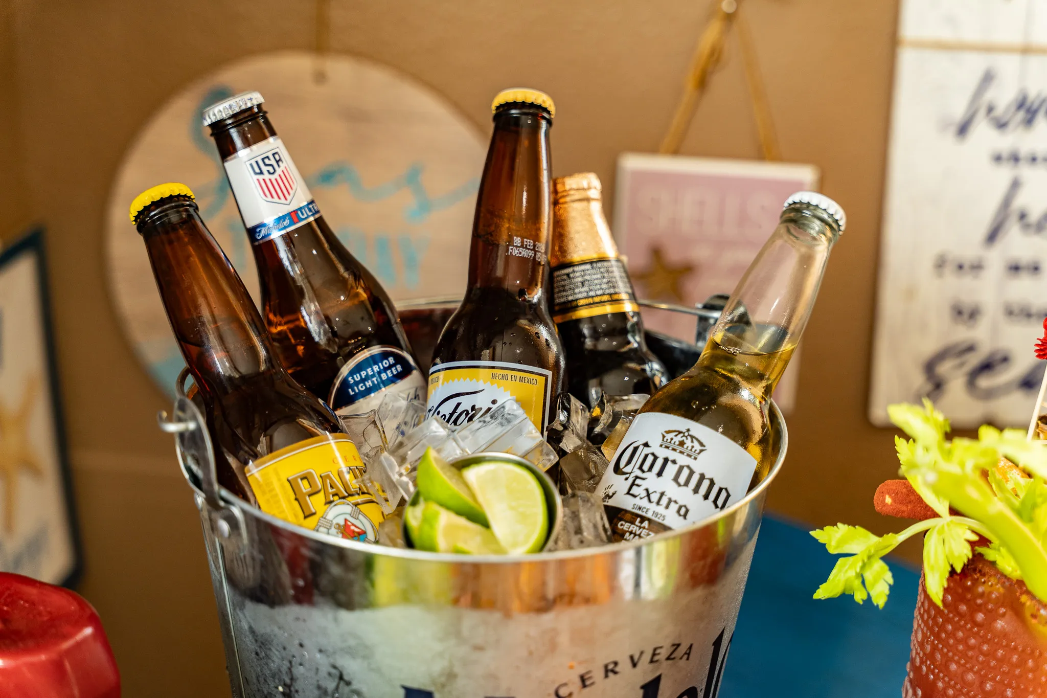 A shiny metal bucket packed with iced Modelo, Corona, Pacifico, Victoria, and Michelob Ultra bottles