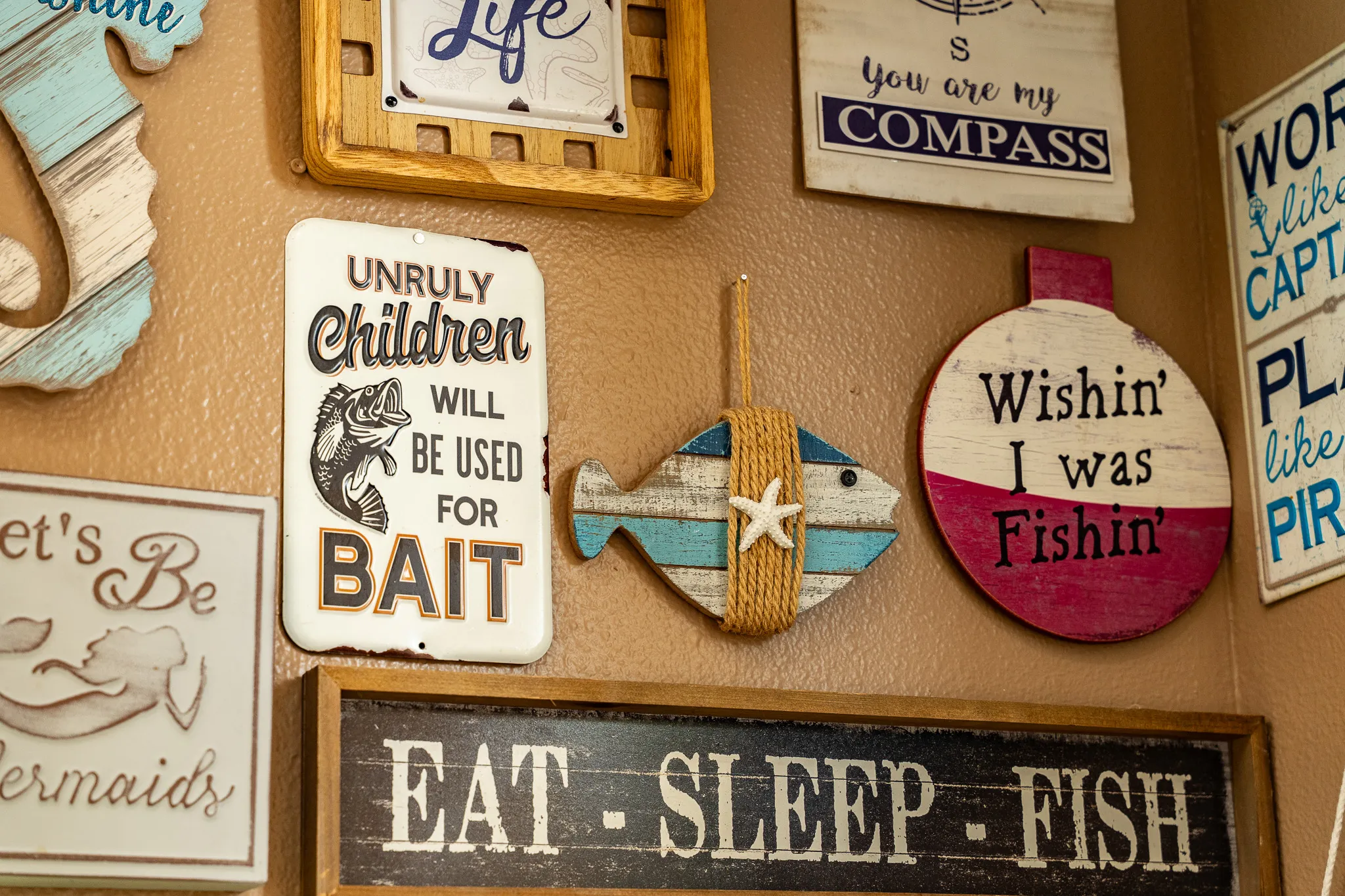 Wacky Crab Shack wall art with "Eat Sleep Fish," "Wishin' I Was Fishin'," and a rustic fish plaque
