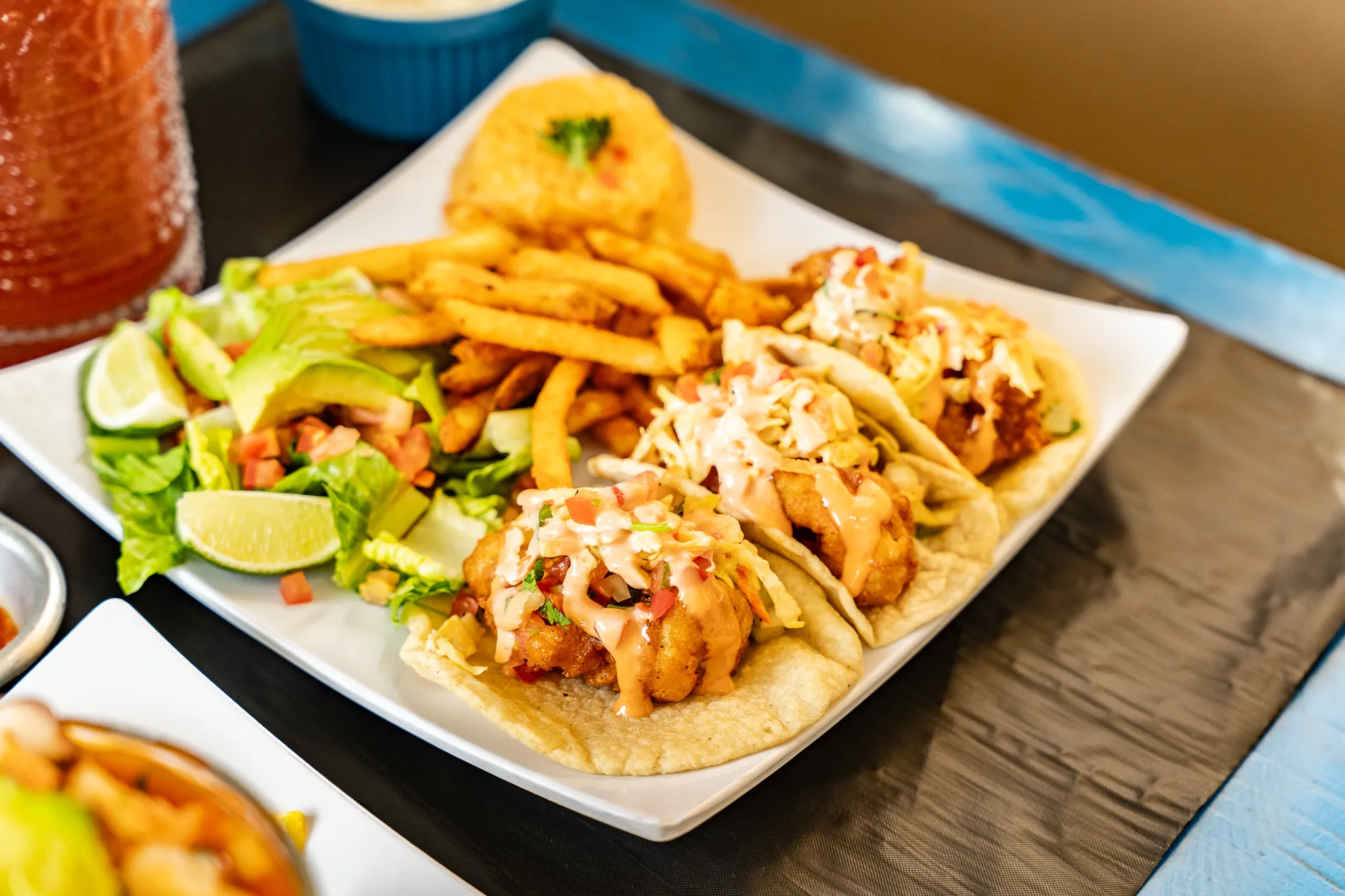 A Wacky Crab Shack Wacky Combo plate with three shrimp tacos, seasoned fries, rice, and salad